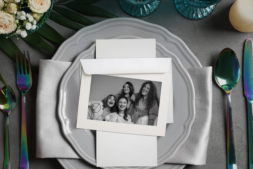 Photo in paper frame on Beautiful table setting on grey background